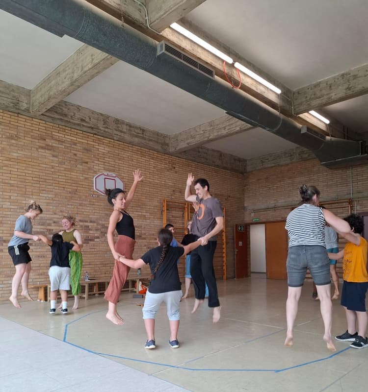 actors jumping with children in catalunya