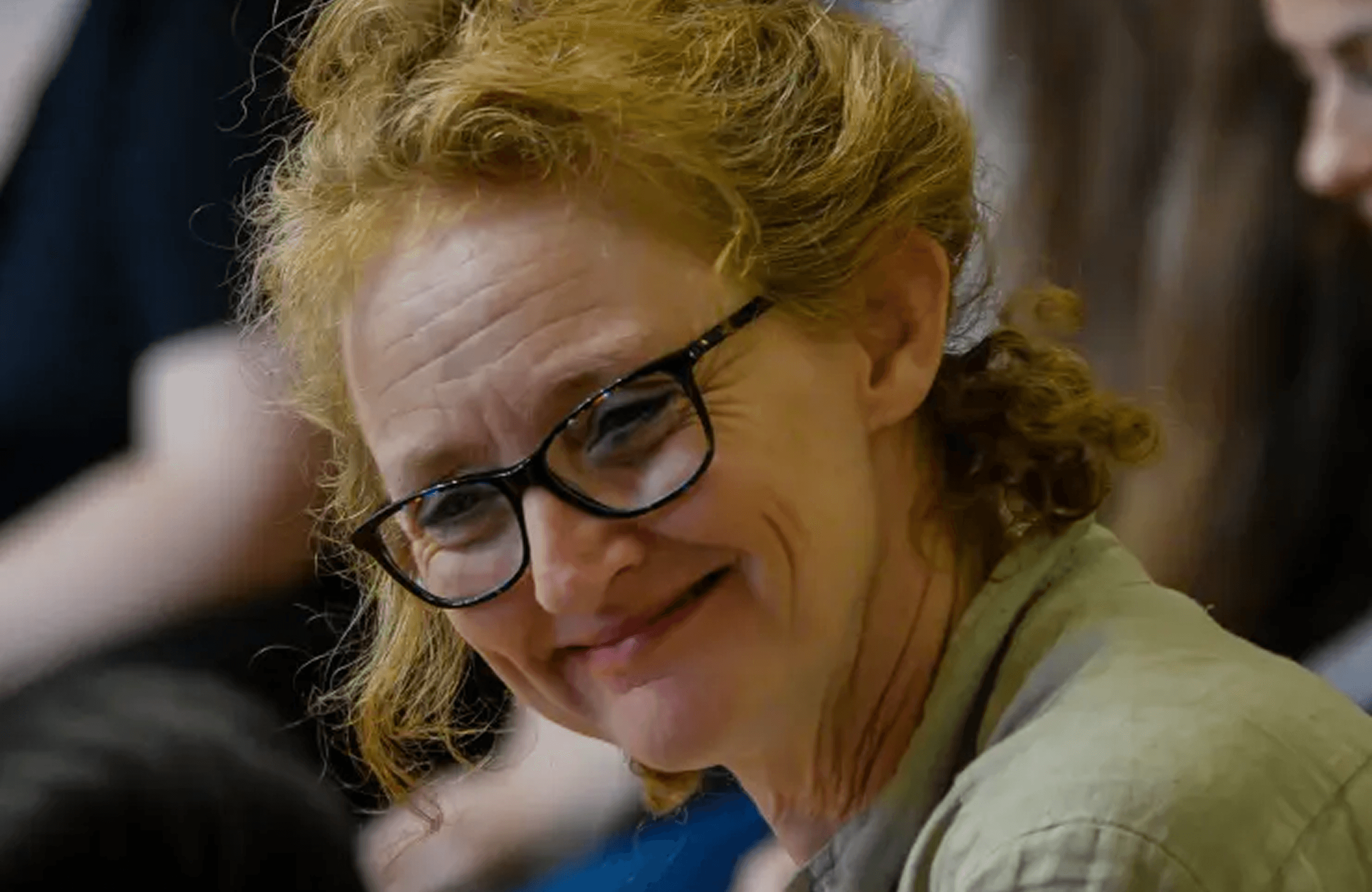 Kelly smiling at an autistic participant in a Shakespeare adaptation